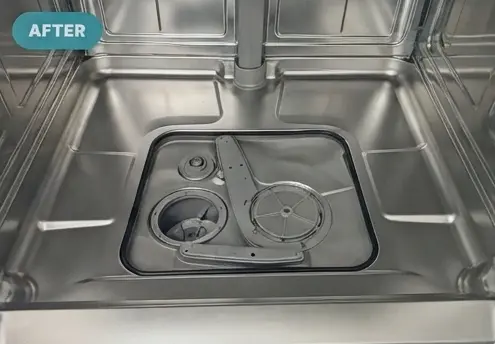 A fully cleaned and serviced dishwasher basin with a spotless stainless steel interior and spray arm.