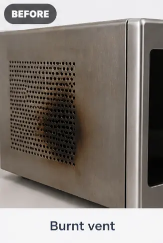Side panel of a microwave with a burnt and scorched ventilation grid.