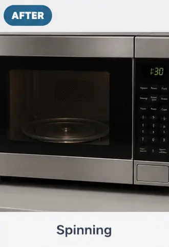 Microwave with a functional rotating glass tray after professional repair.